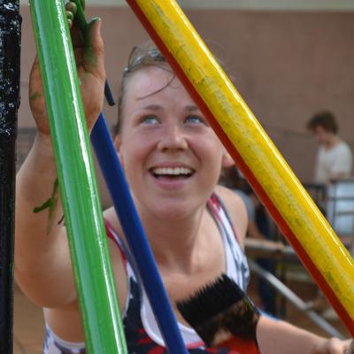 A construction volunteer in Ghana painting a playground structure. A Projects Abroad construction volunteer in Ghana painting a playground.